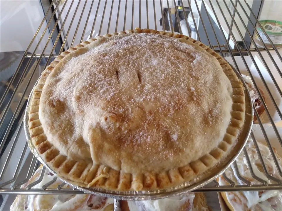 A golden baked pie with a crimped crust